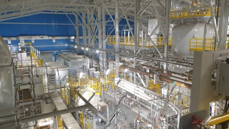 Facility interior with yellow safety rails and walkways