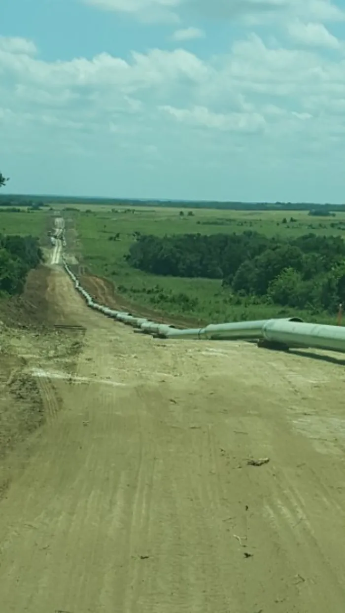 Pipe string laid out along a right of way